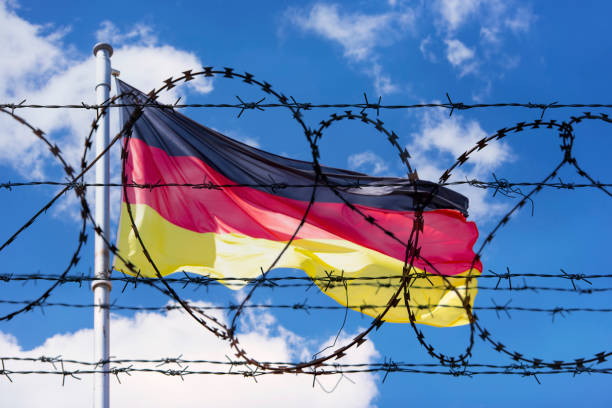 istock Germany Border with Flag of Germany and barbed Wire 959985646