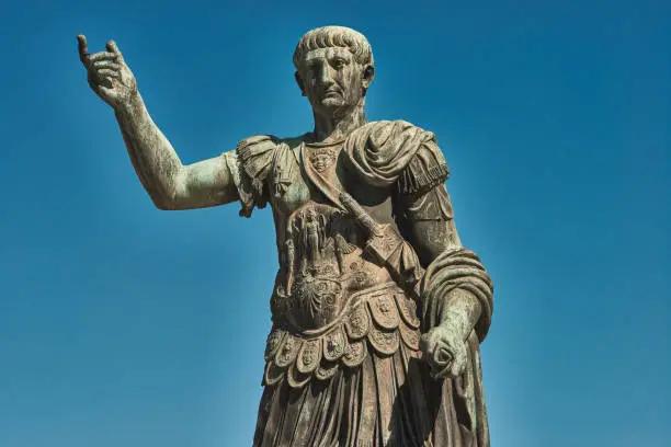 Photo of Rome, Bronze statue of emperor Caesar Nervae Trajan, Forum of Caesar Nervae Trajan in the background