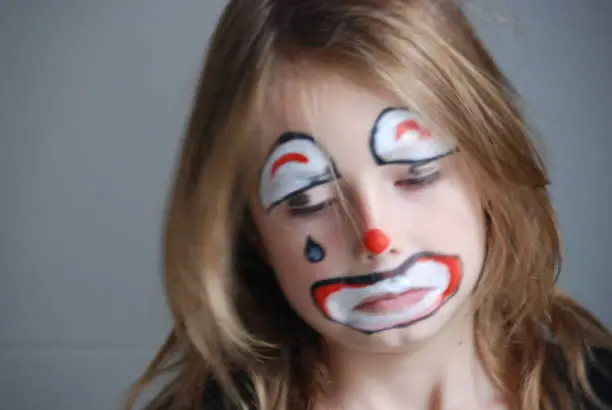 little girl sad clown face paint