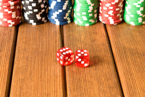 istock Dice and chips on a wooden table. Gambling, poker chips 959993088