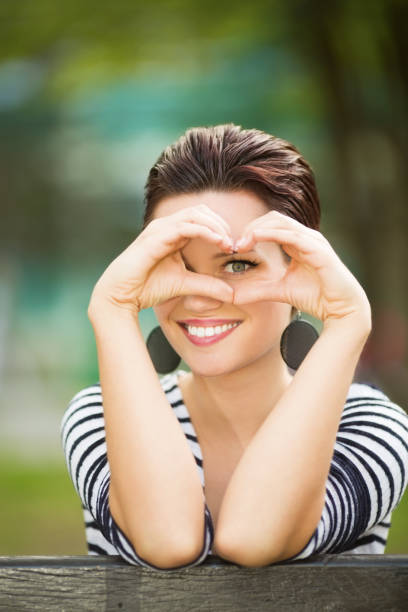 istock Young female student smiling and posing for a camera outdoors 959993578