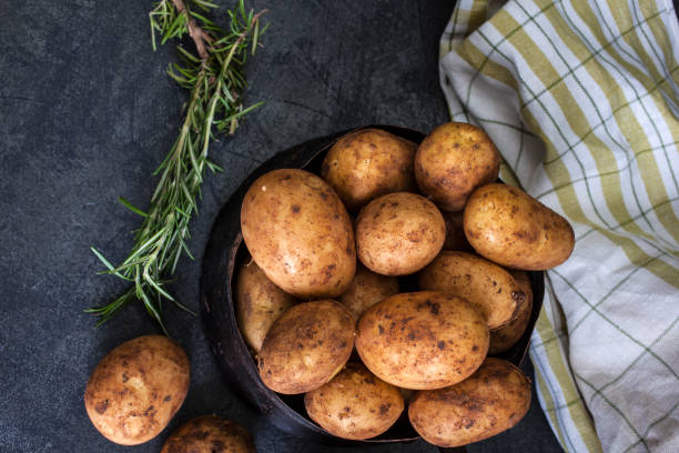 istock New potatoes on dark background 959993668