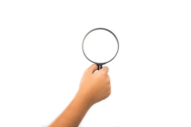 Women hand holding magnifying glass isolated on white background