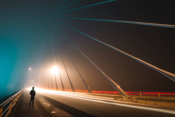 istock Long exposure in foggy night on iron bridge 959994776