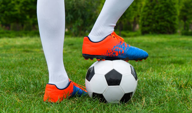 istock Football player and ball on a grass close-up 960001004