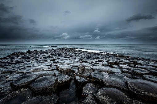 famous giants causeway stones infinity horizon over the atlantic ocean in northern ireland, europe.