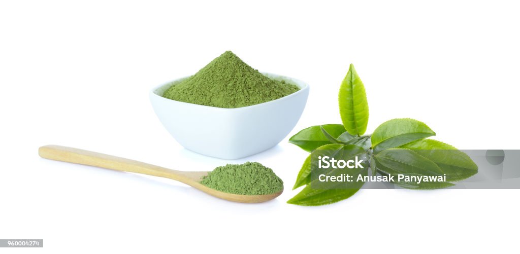 Powder green tea in cup with wooden spoon and green tea leaf on white background and clipping path Matcha Tea Stock Photo