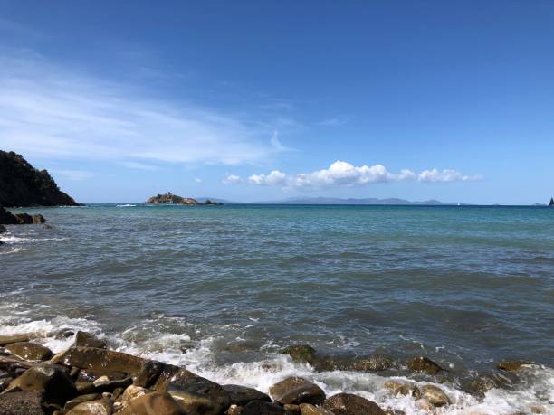 istock Rocky beach with blue sea and view on an island 960008694