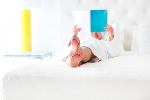 istock Young woman reading book in the bed 960009000