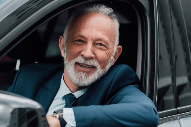 istock Happy senior businessman in a car 960016906