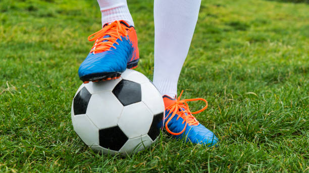 istock Football player and ball on a grass close-up 960017984