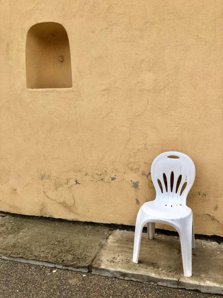 istock Plastic chair at a wall along the road 960017994