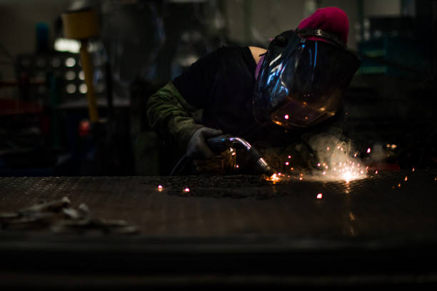 istock Blue collar woman at work. Female welder working in a workshop 960020630