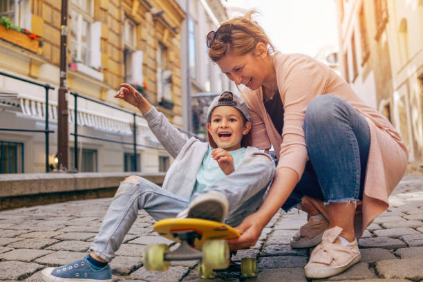 Little skateboarder and his mom