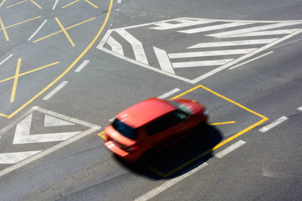 istock A car passing through a junction with a horizontal traffic sign on the road 960021504