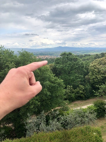 Finger indicating a point in the landscape