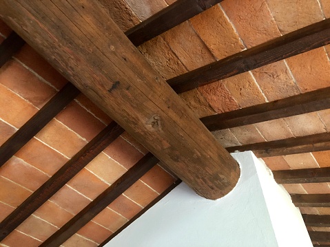 Ceiling detail in ancient wooden beams and bricks