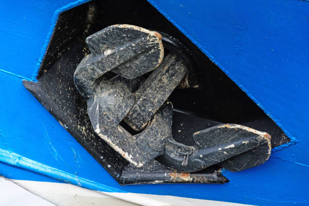istock Black anchor on the bow of blue boat 960021628