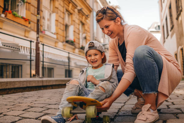 istock Little skateboarder and his mom 960023700