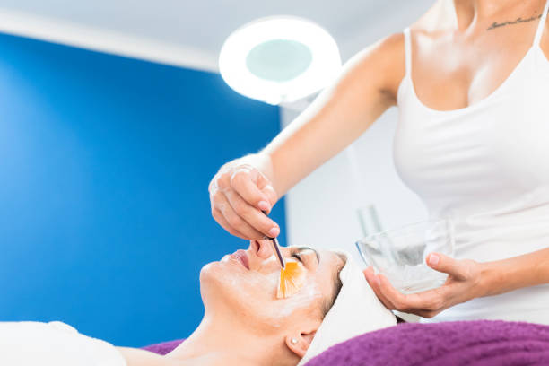istock Beauty therapist applying a face mask to a client 960024328