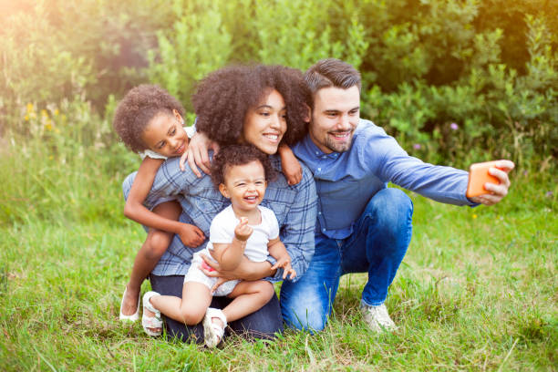 istock Happy family taking a selfie in the park 960026996
