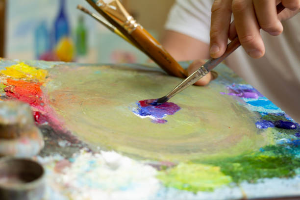 istock The artist's hands are mixing paints with a palette 960028088