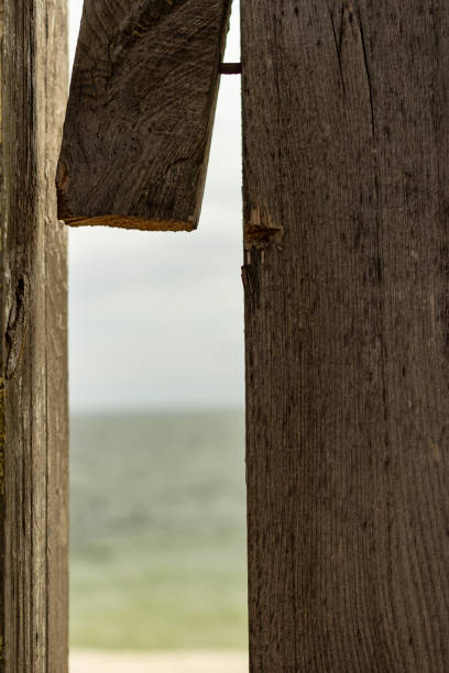old wooden fence, without a harness through which the sea is visible