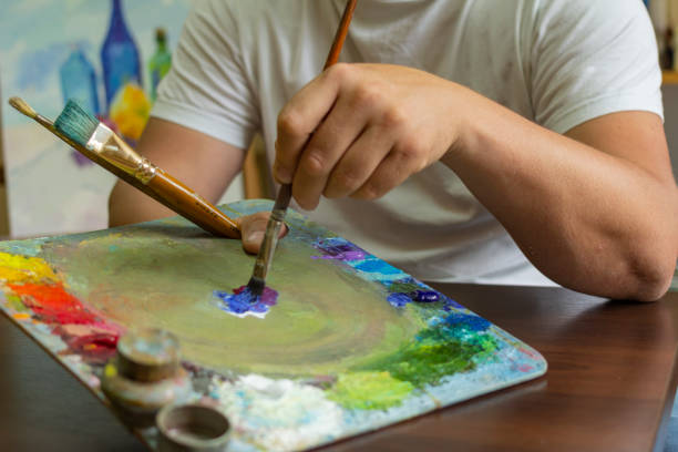 istock The artist's hands are mixing paints with a palette 960028566