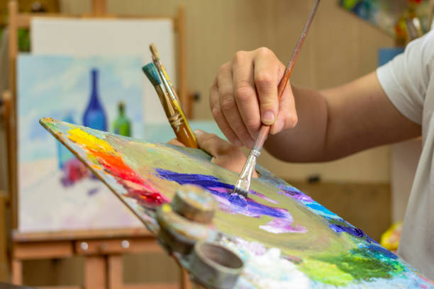 istock The artist's hands are mixing paints with a palette 960028964