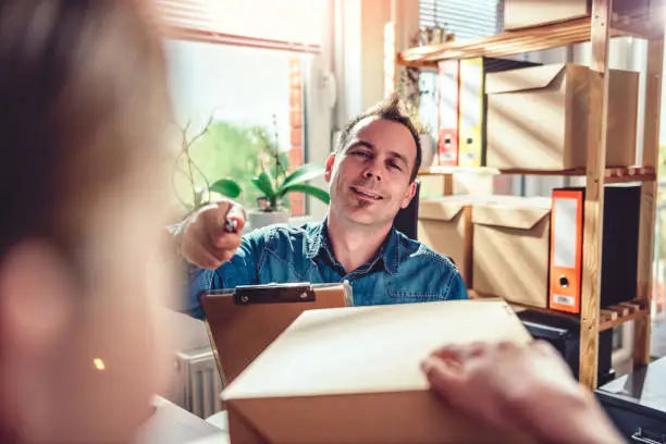 Photo of Men receiving package from courier