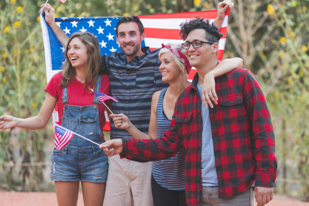 istock Group of millennial friends hold American flags 960035262