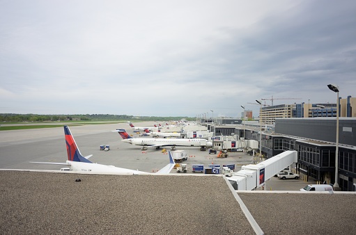 Minneapolis, Minnesota, USA - May 11, 2018: Delta airplanes at concourse C of Minneapolis - St. Paul International Airport near Minneapolis, Minnesota.  Image taken from overlook located in airport.