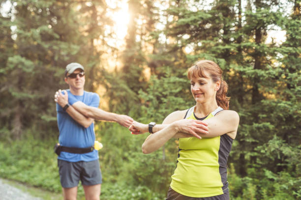 istock Middle-aged couple trail running in the forest 960053158