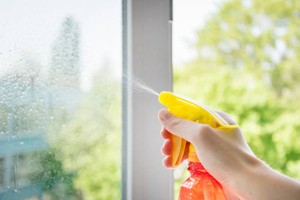 istock Human arm keeping special cleaner for windows 960054126