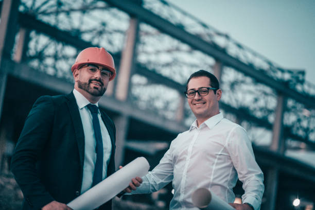 istock Businessmen and Construction Talking about Business Arrangements and Posing 960055034