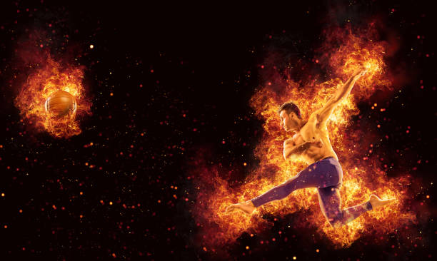 Soccer player barefoot hitting ball in mid-air surrounded by fire and flames