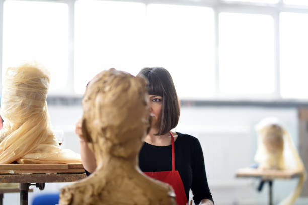 istock Young Female Sculptor is working in her studio 960064660