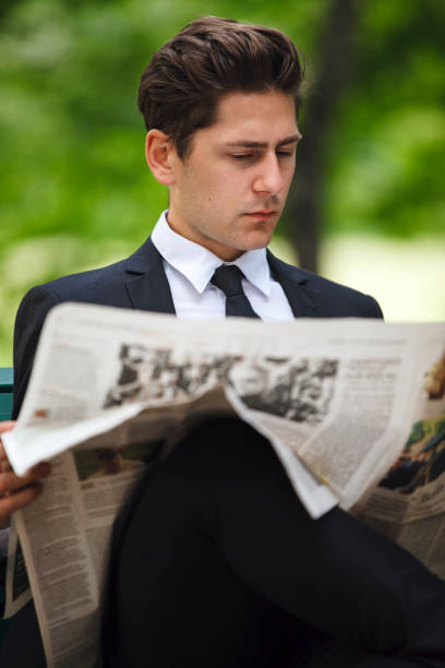 istock Businessman Reading Newspaper In Park 960064926