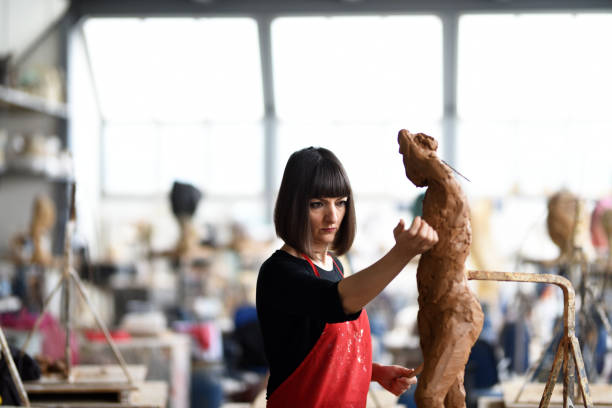 istock Young Female Sculptor is working in her studio 960065032