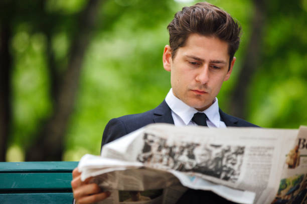 istock Businessman Reading Newspaper In Park 960065376