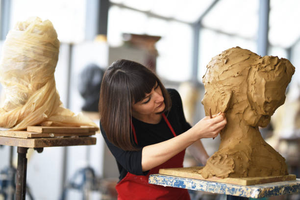 istock Young Female Sculptor is working in her studio 960065562