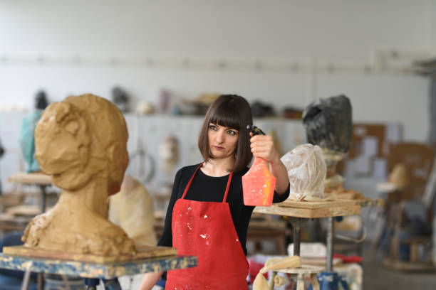 istock Young Female Sculptor is working in her studio 960065666