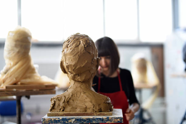 istock Young Female Sculptor is working in her studio 960069292