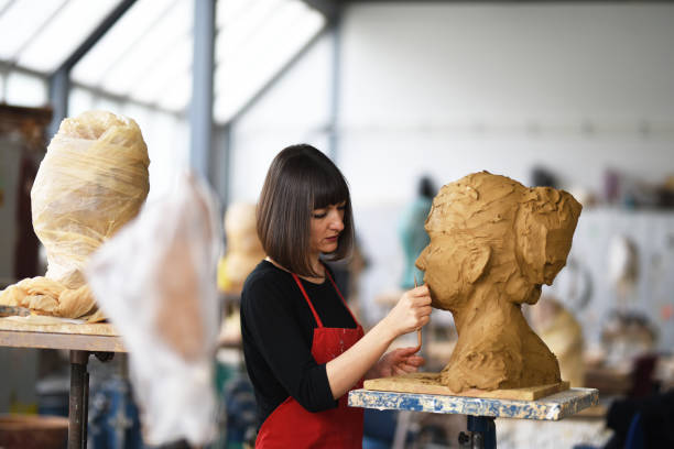 istock Young Female Sculptor is working in her studio 960069606