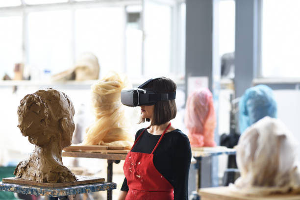 istock Young Female Sculptor is working with VR in her studio 960070064