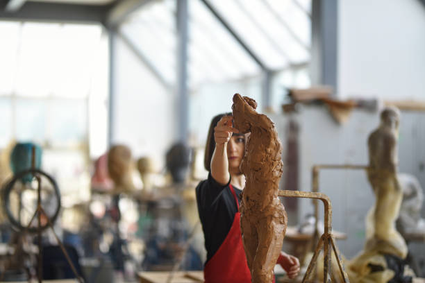 istock Young Female Sculptor is working in her studio 960070546