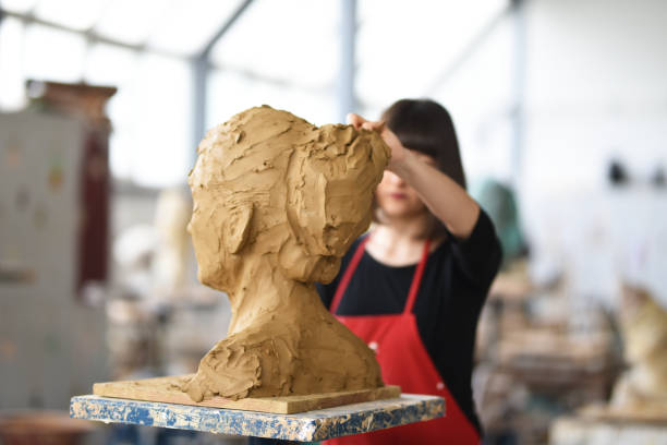 istock Young Female Sculptor is working in her studio 960072904