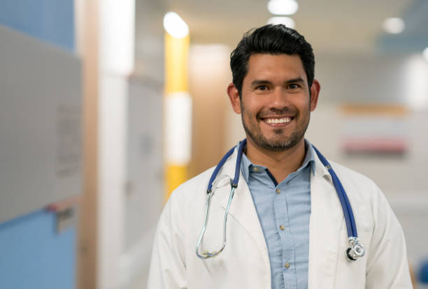 istock Male general practitioner at the hospital looking at camera smiling 960073226