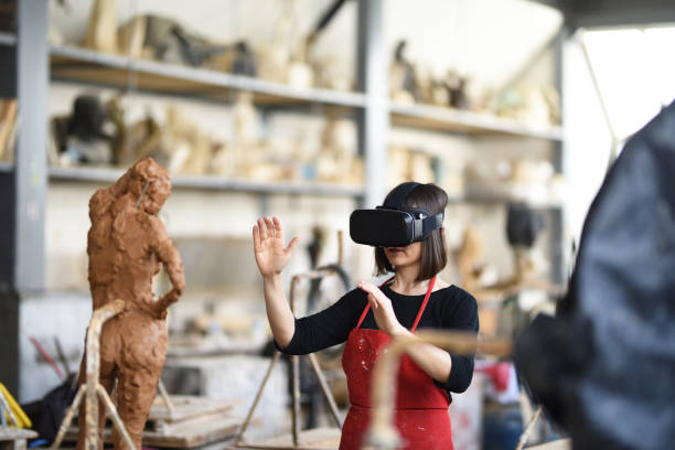 istock Young Female Sculptor is working with VR in her studio 960073572