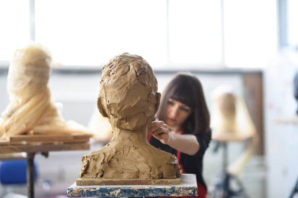istock Young Female Sculptor is working in her studio 960073888